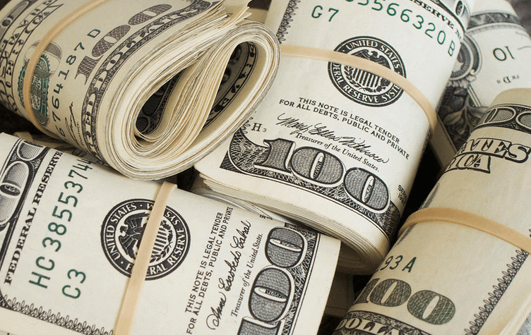 picture of rolls of $100 bills each with an elastic band wrapped around it